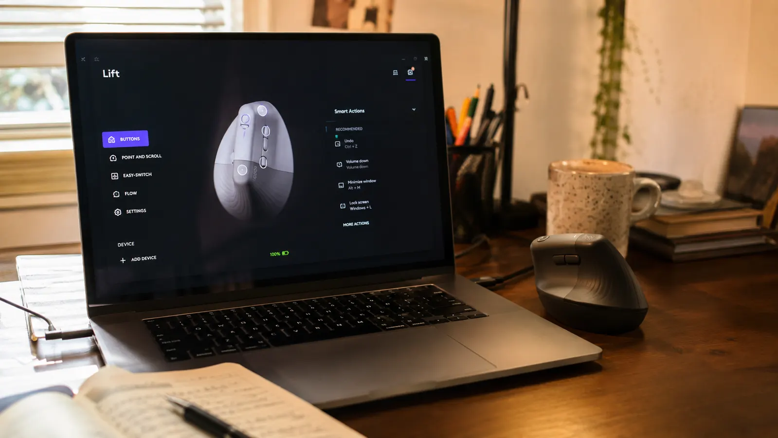 Laptop screen showing the Logi Options plus software installation window next to a vertical mouse
